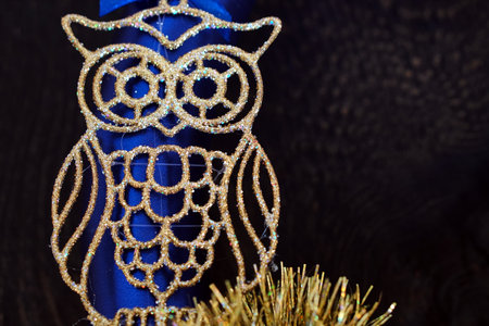 Golden owl in sparkles. Owl outline for christmas. Blue and gold decor.の写真素材
