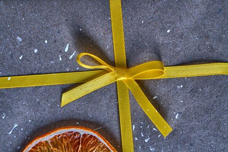 Yellow bow and christmas. Bant on the gift on the packaging.の写真素材