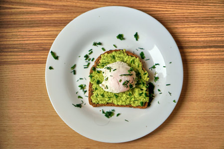 A home made sandwich of avocado and a poached egg. Healthy and healthy food.
