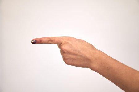 Hand shows gestures and raises her finger to side. finger direction to left.の写真素材
