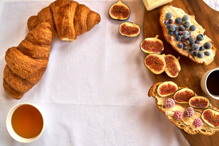 Croissant toast with butter and figs. French dip with raspberries for Breakfast.の写真素材