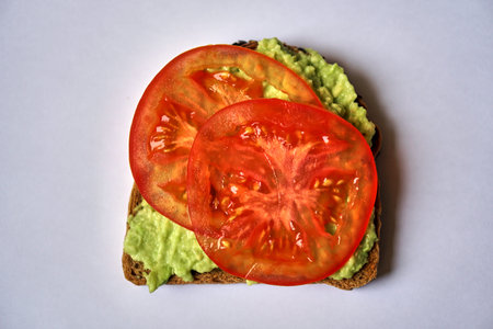 homemade avocado sandwich with tomato or cucumber. Vegetarian breakfast.