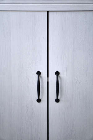 Doors with handles. Blue, white, grey. Wardrobe in the apartment. Style. MAcro.の写真素材