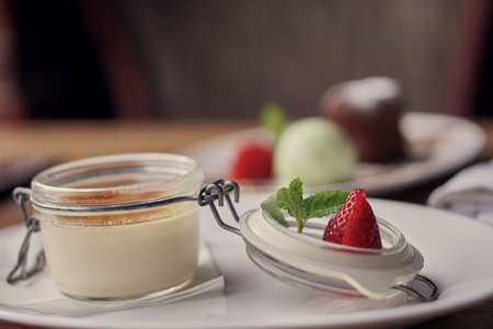 Dessert creme brulee in a jar. Food in restaurant. Sweet in transparent plate.の写真素材