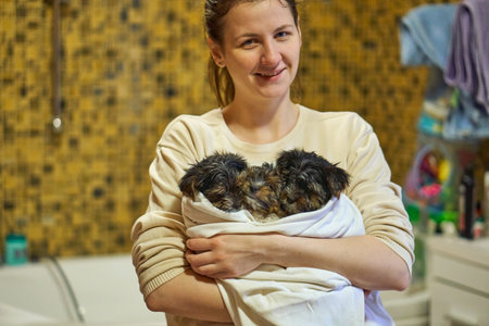 They brought the puppy home. Wash the dog at home and dry it with a towel.