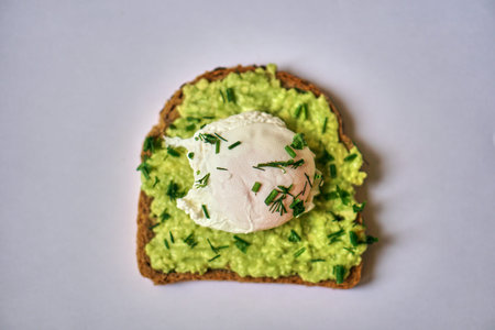 A home made sandwich of avocado and a poached egg. Healthy and healthy food.