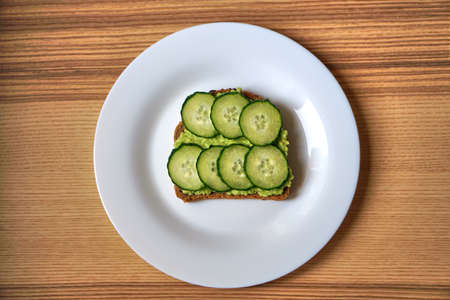 homemade avocado sandwich with tomato or cucumber. Vegetarian breakfast.の写真素材