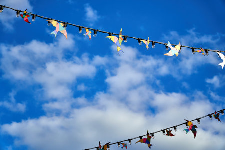 Red white and blue triangular bunting on sky background. Garland of flags stretched against a blue...