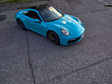 Moscow, Russia 07-02-02019 Porsche 911 Carrera 4S (Miami Blue) 992 Sports aerial survey from a quadcopter a car is parked. The drone shoots a super luxury car from the air.のeditorial素材