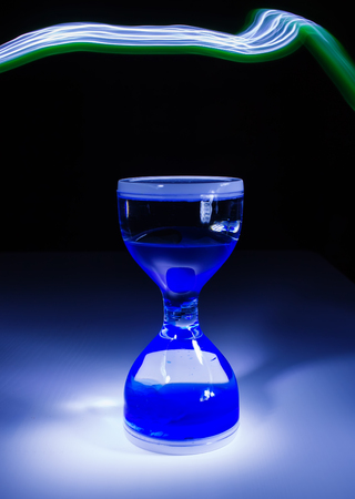 sand glass clock on black background low keyの写真素材