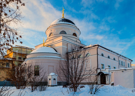 White orthodox church with gold domes against  blue winter skyの写真素材