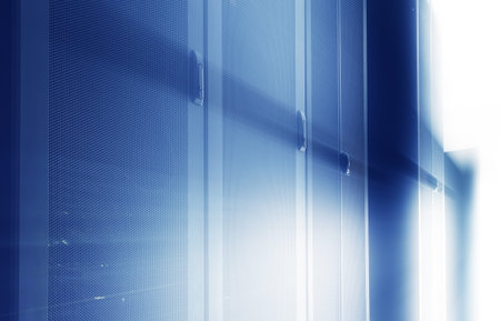 darkened room with rows of modern server hardware in data center