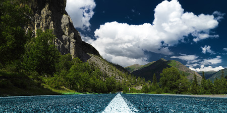 view from ground on a paved road with markingsの写真素材