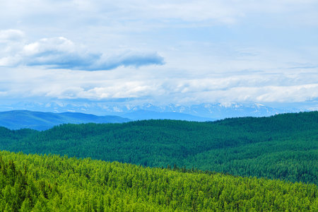 valley in distance against the backdrop of peaksの写真素材