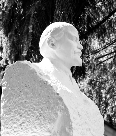 plaster bust of Lenin on background of green summer sunny weatherの写真素材