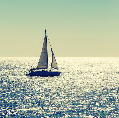 Sailing ship yachts with white sails in the open sea