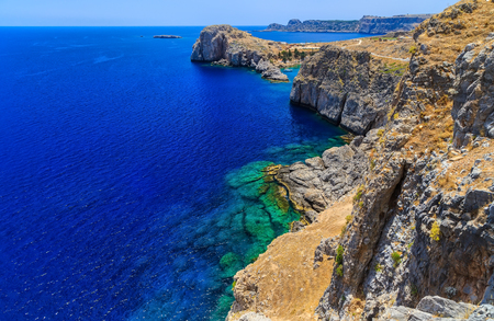 view from the top of the cliff on the open sea and the bay with rocksの写真素材