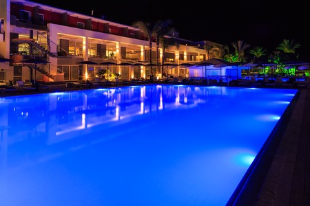 swimming pool with lighting in spa modern European hotel at nightの写真素材