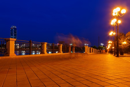 Quay road and stone wall at nightの写真素材