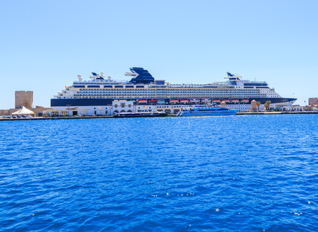 cruise ship, and ships with masts and sails into the port of Rhodesの写真素材