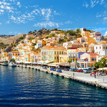 Greece. Dodecanesse. Island Symi Simi . Colorful houses on rocksの写真素材