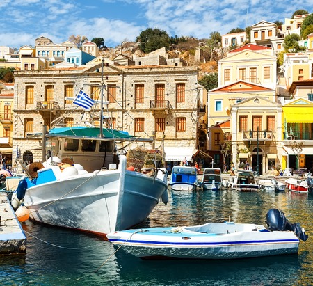 Symi island - Colorful houses and small boats at heart of the villageの写真素材