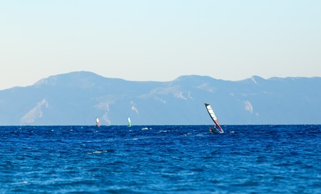 group of windsurfers on a background mountains in the Aegean seaの写真素材