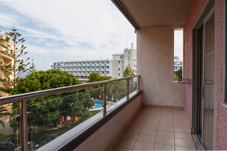 Terrace lounge with rattan armchairs and city view in a hotel.の写真素材