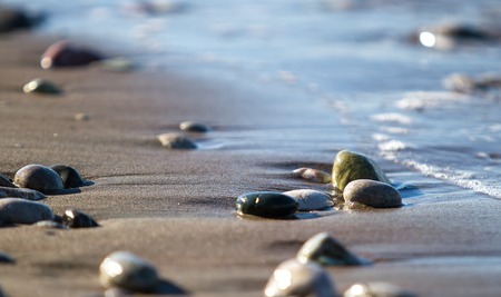 pebbles among the sand on the seashore. Close-up blurの写真素材