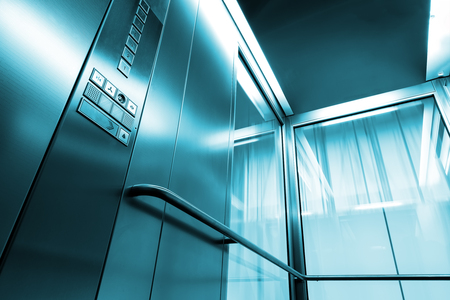 Inside metal and glass Elevator in modern building , the shiny buttons and railingsの写真素材