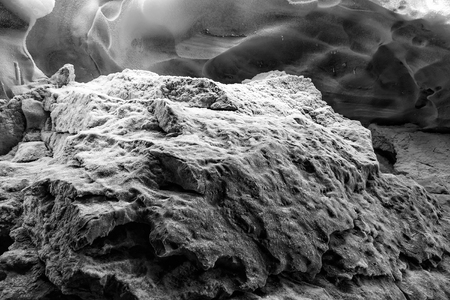 Close up black and white frosted rock amid the frozen texture of iceの写真素材