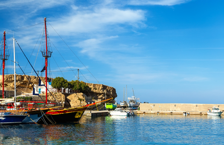 Port of Hersonissos with Boats in Blue Water and Hills on the Background, Crete Island, Greeceの写真素材