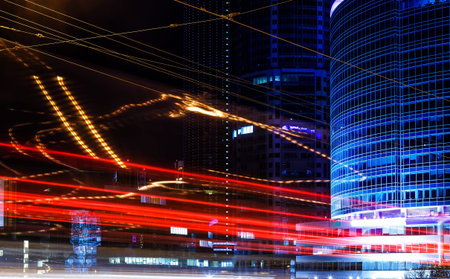 bright trails lights, blurred long exposure on the modern building background