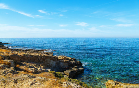 Volcanic rock on shore of the island of Crete Greece, cloud sun weatherの写真素材
