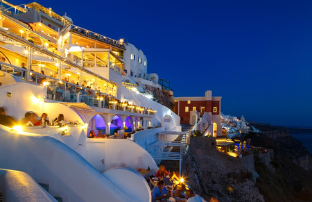 Night restaurant with tourists from Fira Santorini, the famous European resort, Greeceの写真素材