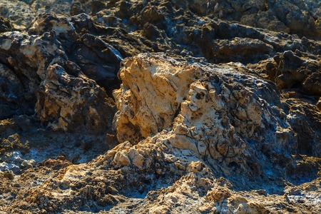 Volcanic stone formations on beach. Natural texture with blurの写真素材