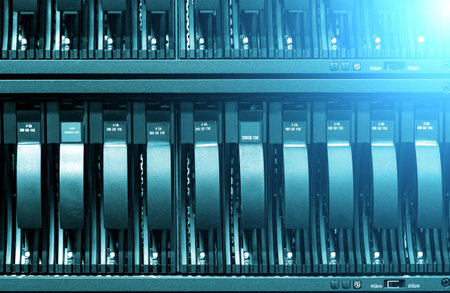 Row of hard disks close-up with ligh. The concept of information technology .