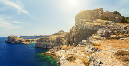 Summer bottom cliff view Acropolis of Lindos of Rhodes with dramatic sky backgroundの写真素材