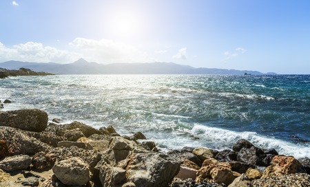 Inspirational beautiful mountains landscape with sea, coast, beach and rocks, high mountains in background at sunrise on Crete Island, Greece.の写真素材