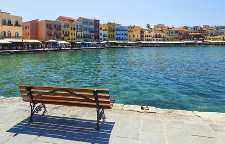 view of waterfront promenade with tourists, bars, hotels and restaurants in central historic part of Chania on sunny summer day, Crete, Greeceの写真素材