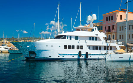 Large private luxury yacht moored in embankment the Old Town of Chania