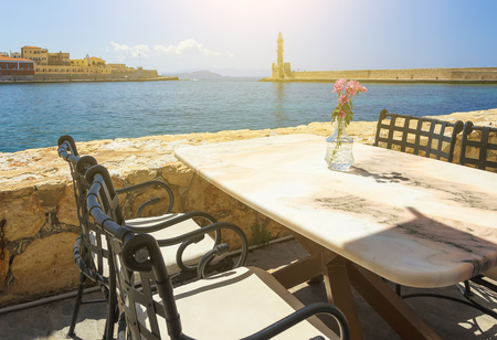 Cafe with marble tables on sea coast in Chania, Crete island, Greece. Selective focusの写真素材