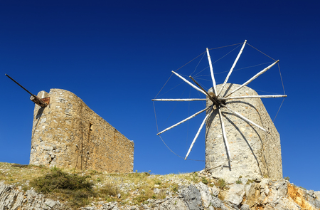 Traditional old windmill on the island Crete, Greece. Beautiful landscape with blue skyの写真素材