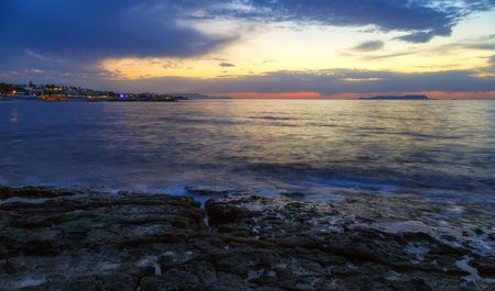 Nature in twilight period which including of sunrise over the sea and the nice beach. Summer beach with blue water and purple sky at the sunset.の写真素材