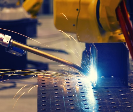 Close up robot welding automotive part in car factoryの写真素材