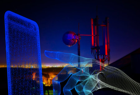 Telecommunications tower, antenna and satellite dish and city at night