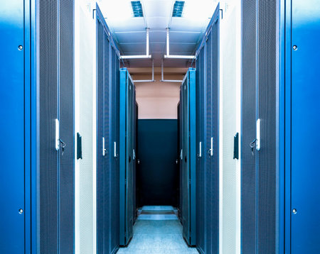 Data centre interior with server racks of hardware equipment performing functions of processing,...