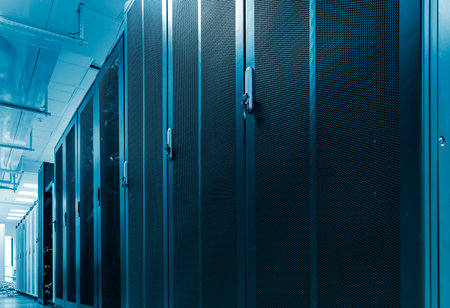 Long row of racks with mesh doors in big data center. Server hardware box with network...