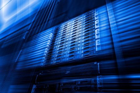 Point of bottom view of array disk storage in data center with depth of field in cool blue tone....