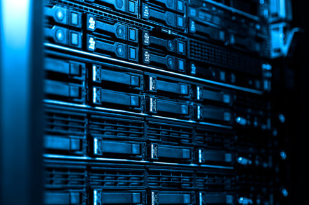 Close up blade server equipment rack and storage in big data center. Technological background with...